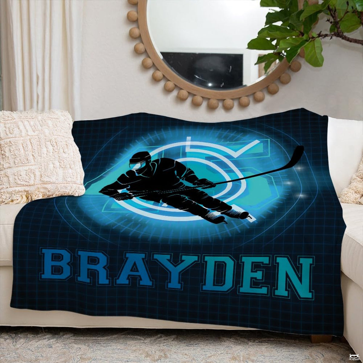 Ice hockey skater sports blanket styled neatly across an ivory living room couch.
