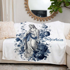 Catholic floral Blessed Mother blanket styled neatly across an ivory living room couch.