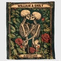 Gothic skeleton couple throw blanket featuring embracing skeletons kissing among red roses.