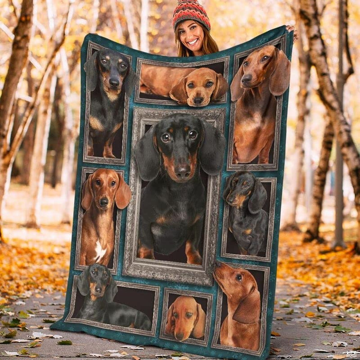 Model displaying the rectangular Dachshund portrait blanket outdoors in an autumn park.