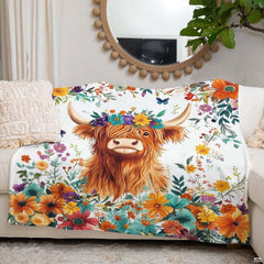 Bedroom styled with botanical garden Highland cow throw blanket displayed across rustic bedding