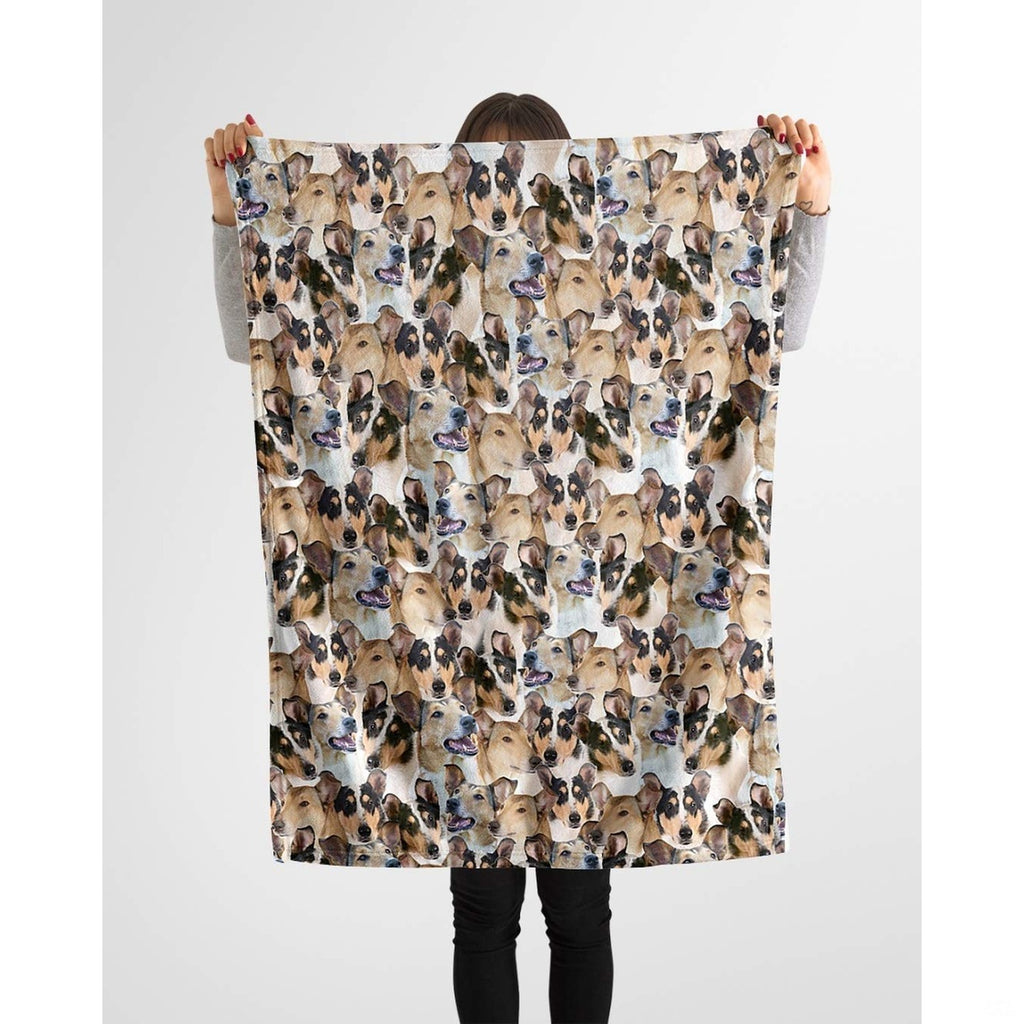 Model holding up a repeating collie canine blanket against a plain background.