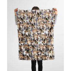 Model holding up a repeating collie canine blanket against a plain background.