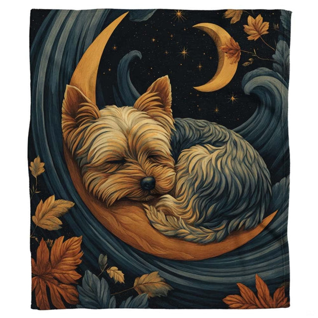 Close-up of the peacefully sleeping Yorkie face nestled inside the curved golden crescent moon on a blanket