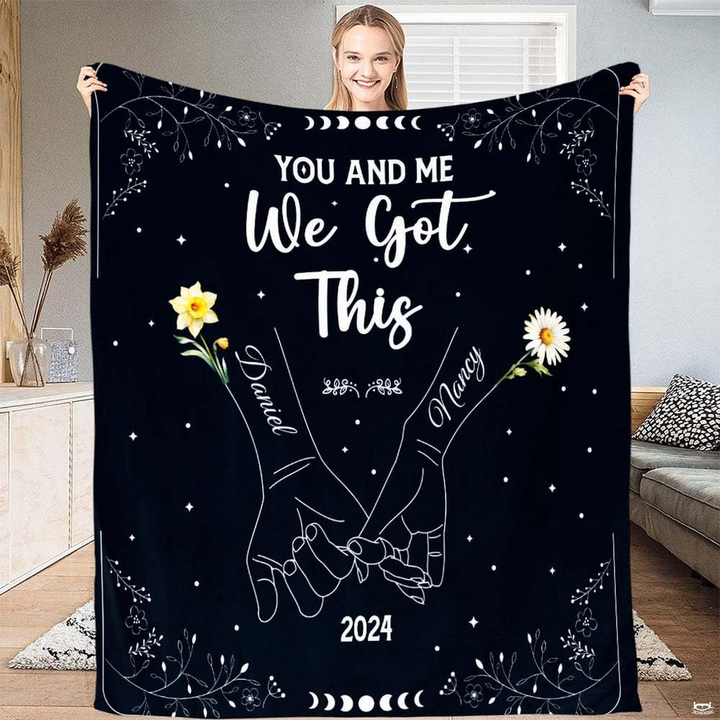 Full view of throw blanket displaying pinky promise hands line art, daffodil, daisy, and moon phases.