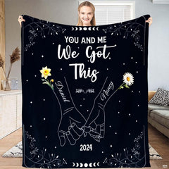 Full view of throw blanket displaying pinky promise hands line art, daffodil, daisy, and moon phases.