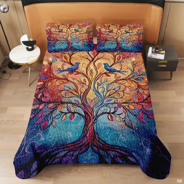 Close-up perspective of artistic bedding detailing mosaic glass-style leaves, perched songbirds, and jewel-tone gradients