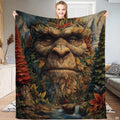 Bigfoot forest spirit throw blanket showcasing mythical Sasquatch face woven from autumn leaves and pine trees
