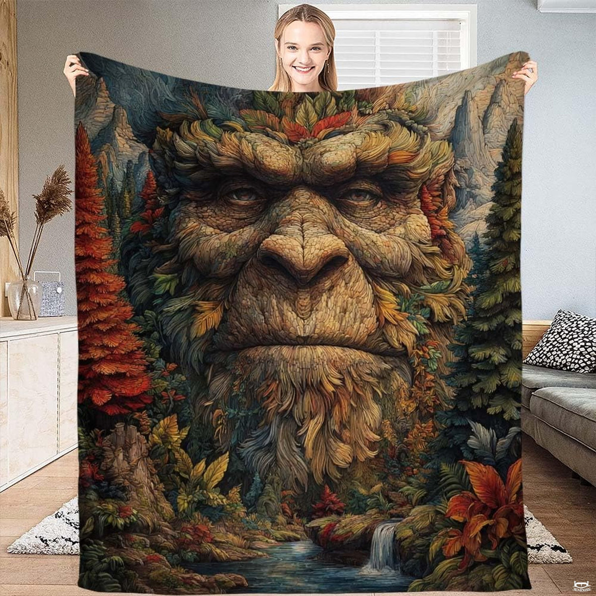 Bigfoot forest spirit throw blanket showcasing mythical Sasquatch face woven from autumn leaves and pine trees