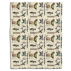 Rustic wildlife throw blanket featuring an outdoor pattern of whitetail deer, leaping bass, mallard ducks, and fishing rods