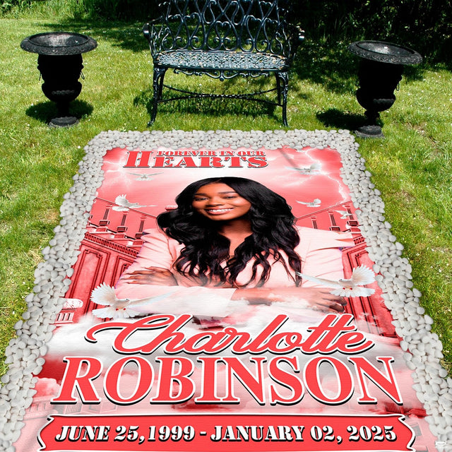 Memorial throw blanket displayed across outdoor garden lawn near decorative wrought iron bench