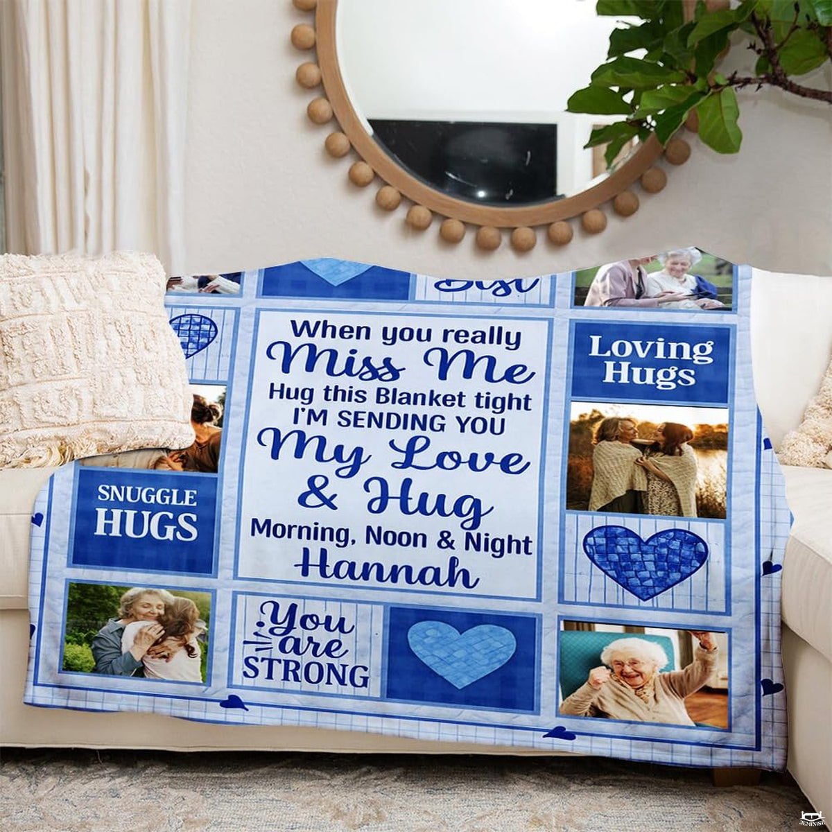 Family sentiment collage blanket styled across a living room sofa in a modern home