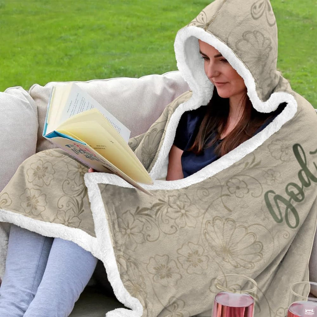 Folded corner view of botanical scripture hooded blanket showing scrollwork border