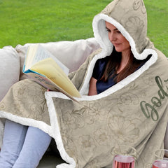 Folded corner view of botanical scripture hooded blanket showing scrollwork border