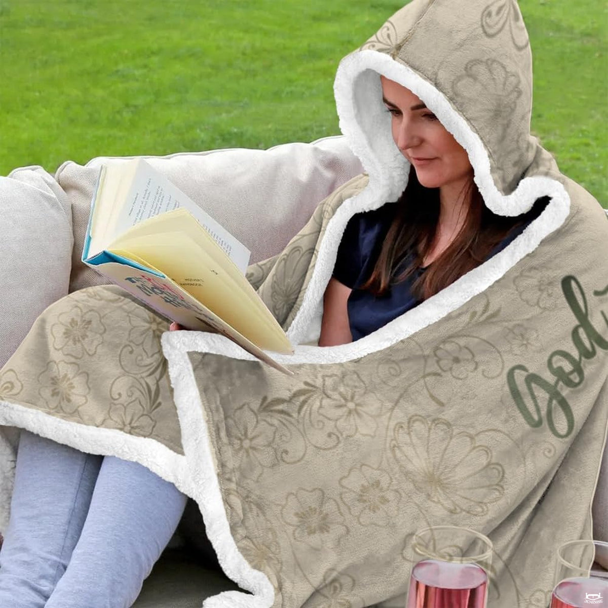 Folded corner view of botanical scripture hooded blanket showing scrollwork border
