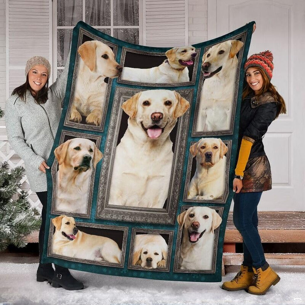 Two models displaying the Yellow Labrador Retriever blanket outside a snowy winter home entrance.