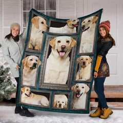 Two models displaying the Yellow Labrador Retriever blanket outside a snowy winter home entrance.