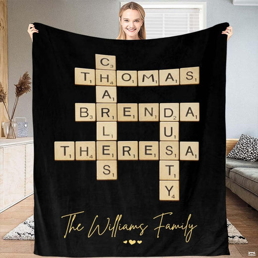 Black crossword letter tiles blanket featuring interlocking wooden alphabet tiles and golden accents.