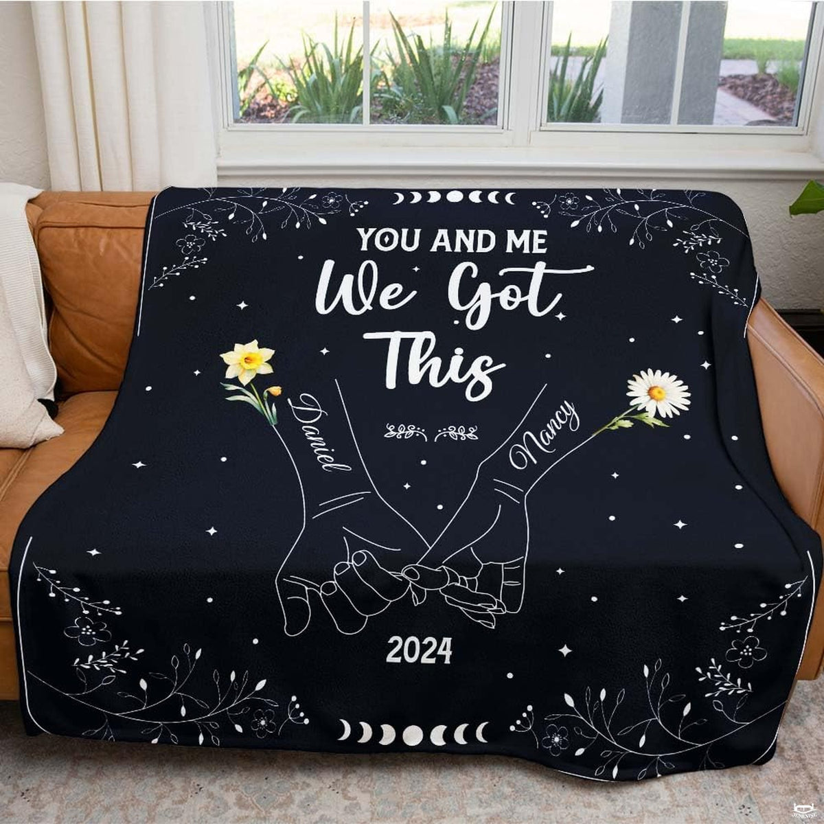 Folded throw blanket presentation highlighting white linework on deep black field.