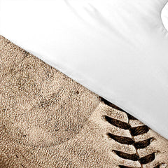 Folded presentation of baseball helmet bedding displaying sharp graphic clarity in neutral beige and tan tones