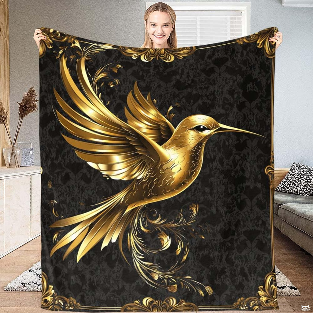 Golden hummingbird blanket with Baroque scrollwork borders on black damask.