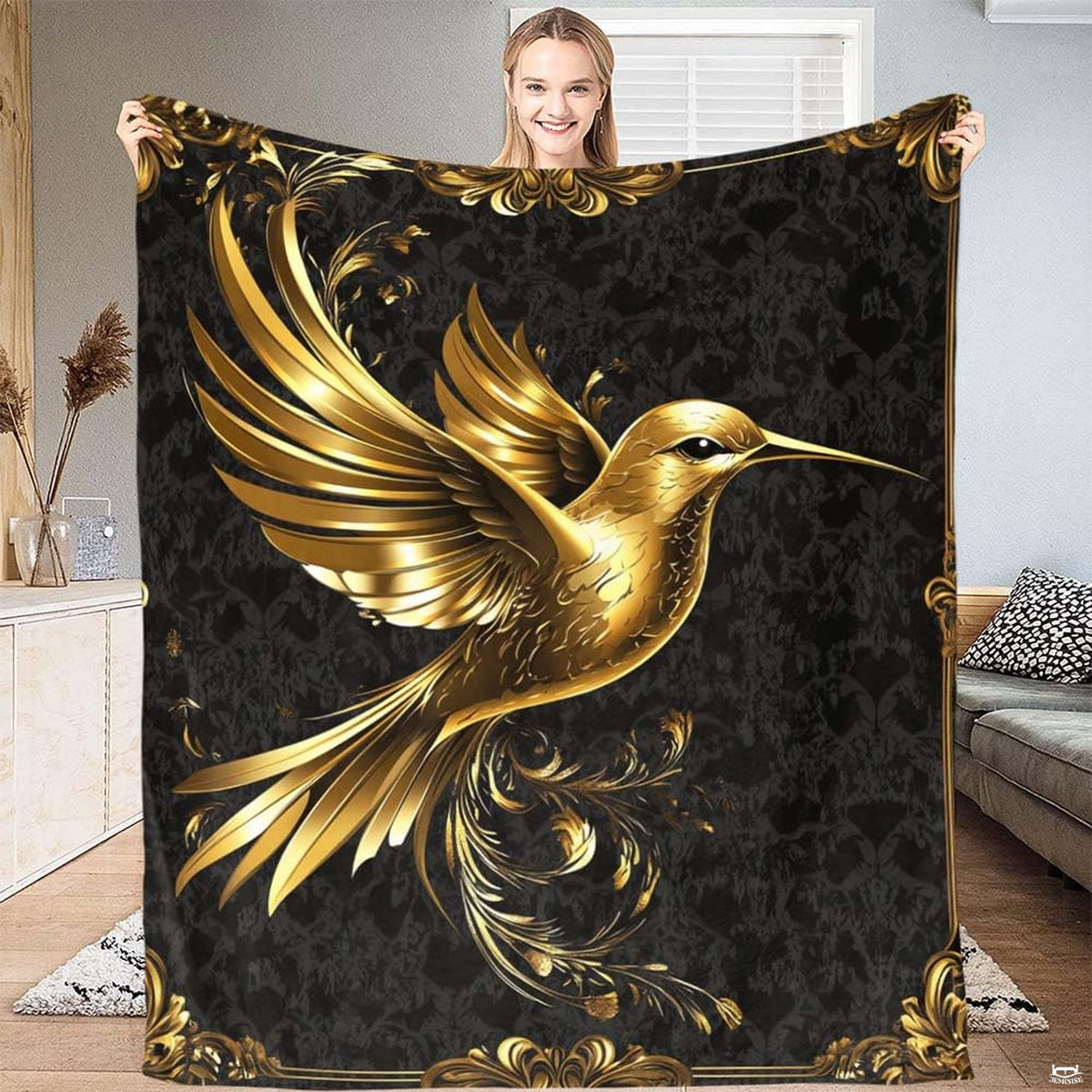 Golden hummingbird blanket with Baroque scrollwork borders on black damask.