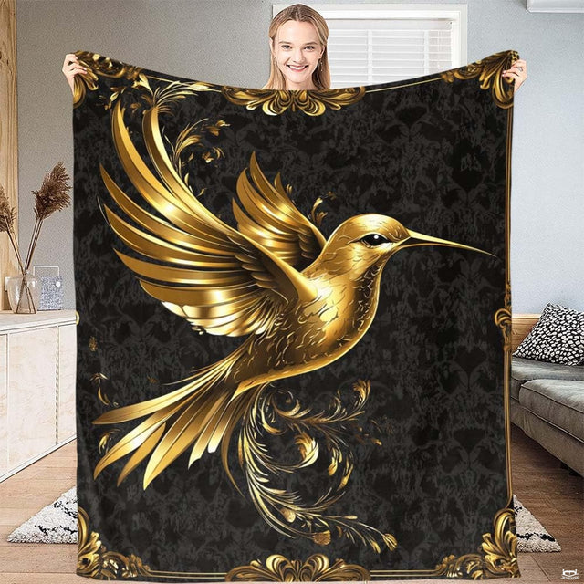 Golden hummingbird blanket with Baroque scrollwork borders on black damask.