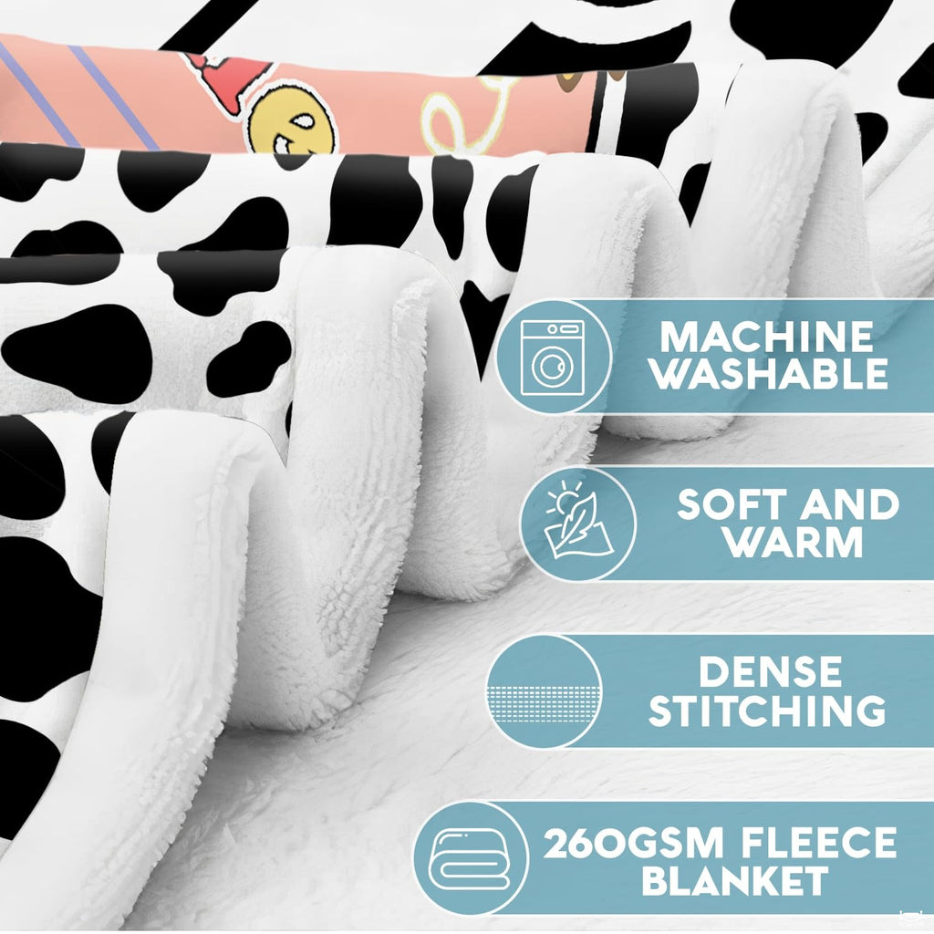 Spotted schoolhouse throw blanket featuring cow print, pink pennant bunting, and school bus stickers.