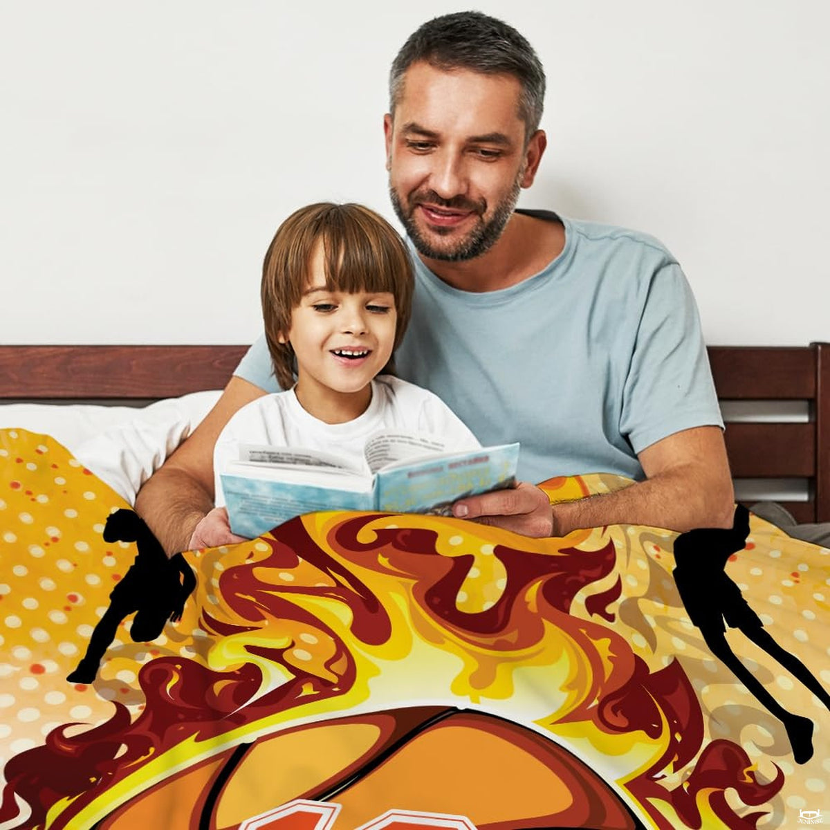 Close-up of dynamic sports bedding artwork displaying crimson flames and black basketball player silhouettes.