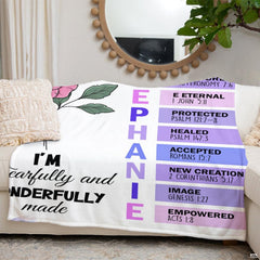 Folded faith blanket displaying soft purple butterfly borders.