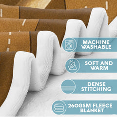 Whitetail buck wildlife throw blanket styled across a couch in a rustic lodge.