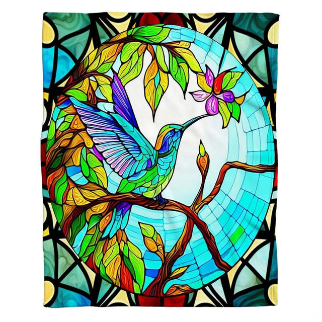 Lifestyle display of a person resting with the stained glass hummingbird throw blanket.