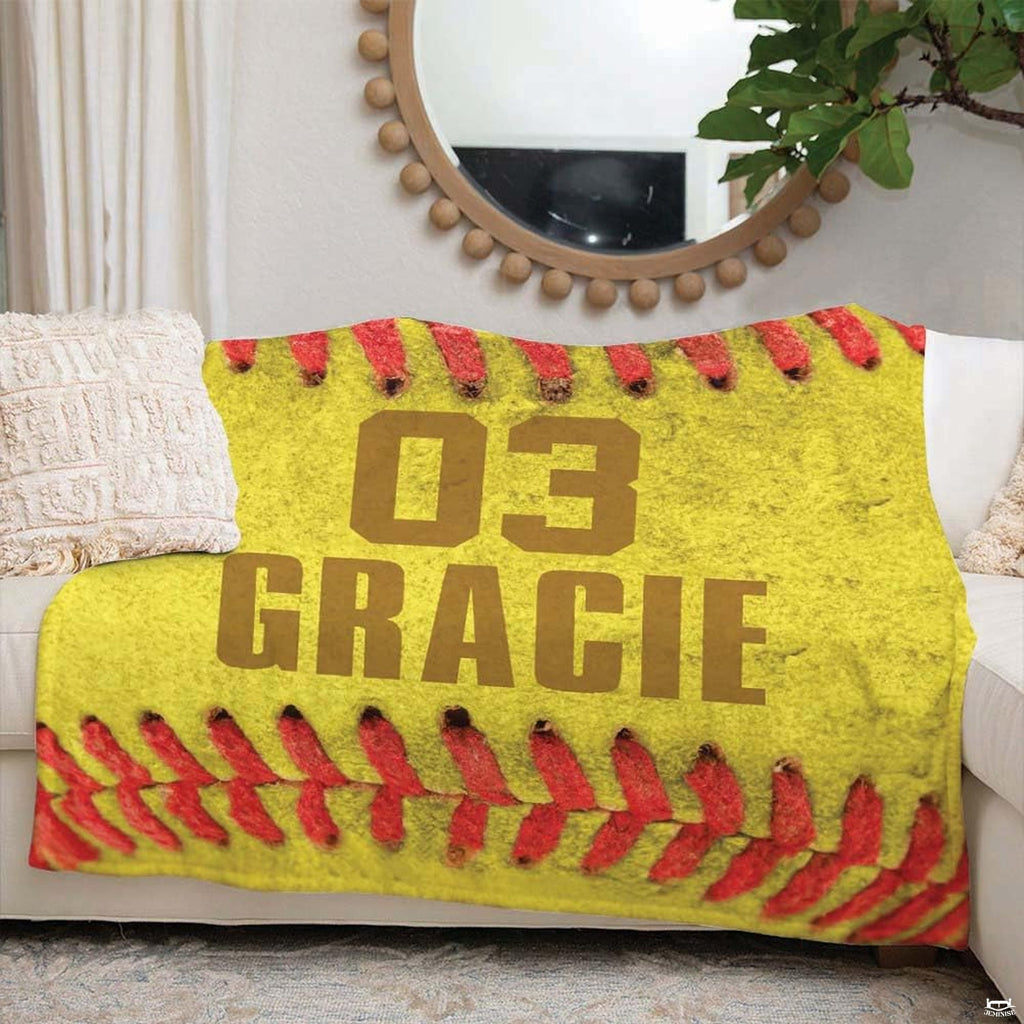 Bedroom interior display showing macro softball throw blanket styled on modern accent seating