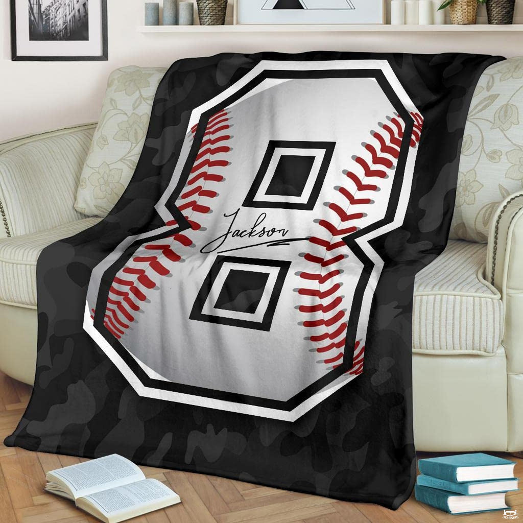 Dark bedding set double featuring grey camo and baseball graphics spread over a bed.