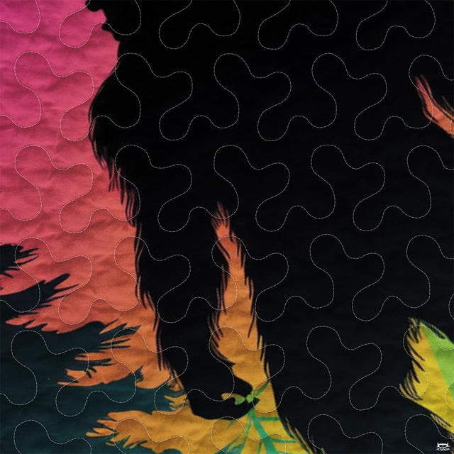 Close-up view of Bigfoot bedding showcasing vibrant sunset glow, evergreen pines, and Sasquatch silhouette