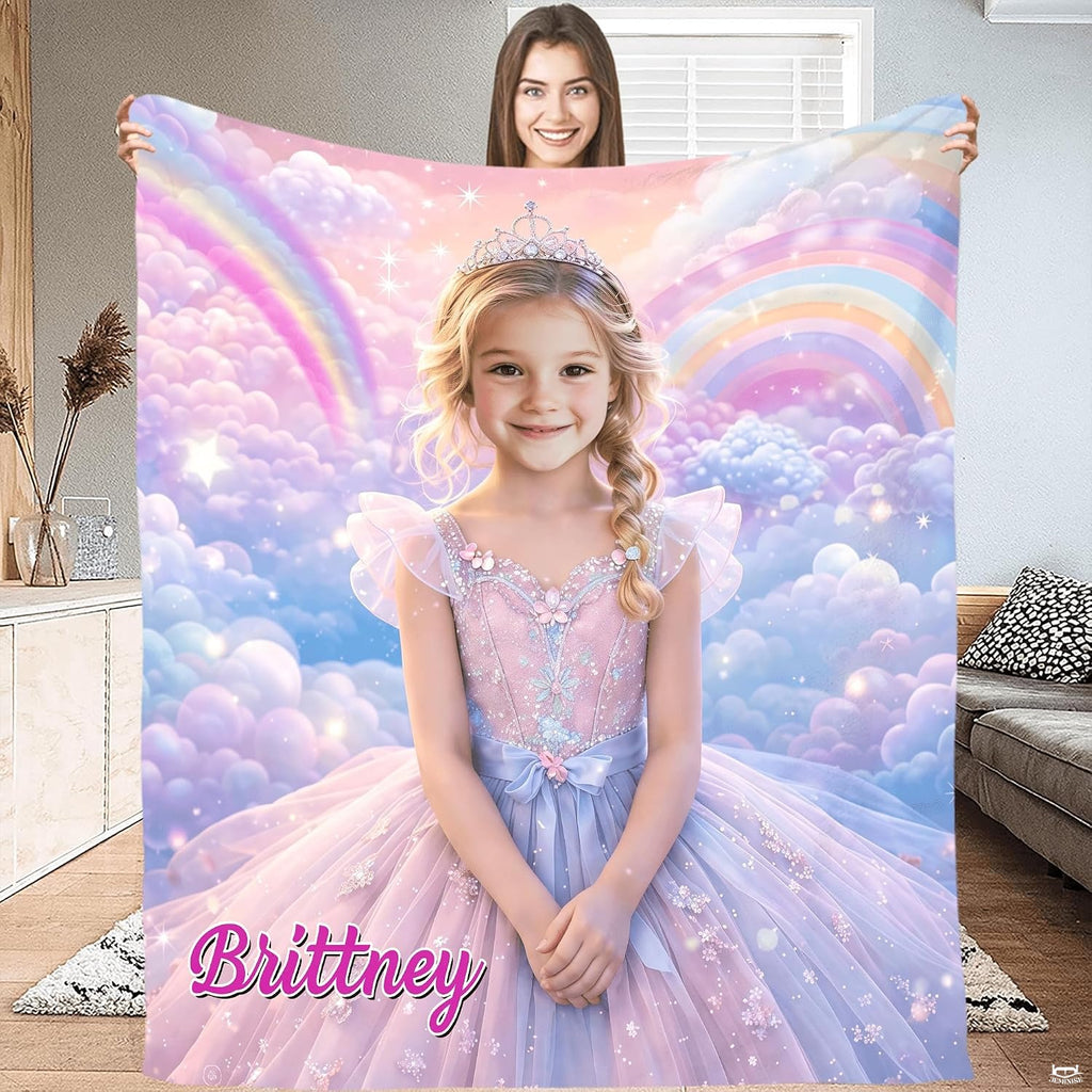 Model holding open a princess blanket featuring a girl in a tiara and gown surrounded by pastel rainbows.