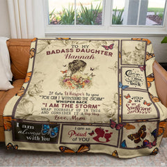 Detail of motivational typography panels and vibrant orange monarch butterfly graphics on a blanket
