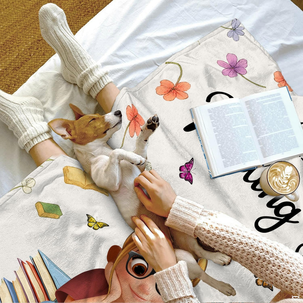 Bedroom interior showcasing the carnation reader girl throw blanket displayed over an accent lounge armchair.