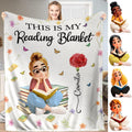 Carnation reader girl throw blanket displaying an illustrated girl seated on stacked books beside a red flower.