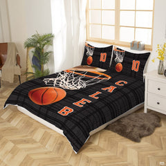 Top-down view of orange and black basketball hoop bedding set arranged neatly on a youth bedroom mattress