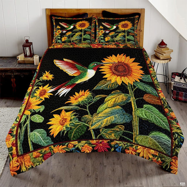 Green and red hummingbird approaching yellow sunflowers on black bedding art