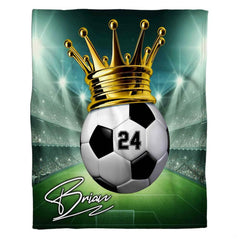 Graphic soccer championship design blanket spread flat showing crowned ball and illuminated arena.