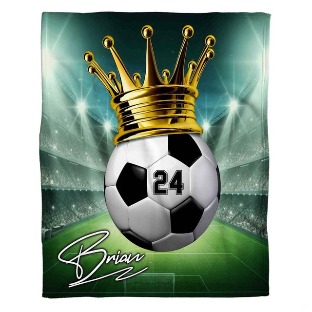 Graphic soccer championship design blanket spread flat showing crowned ball and illuminated arena.