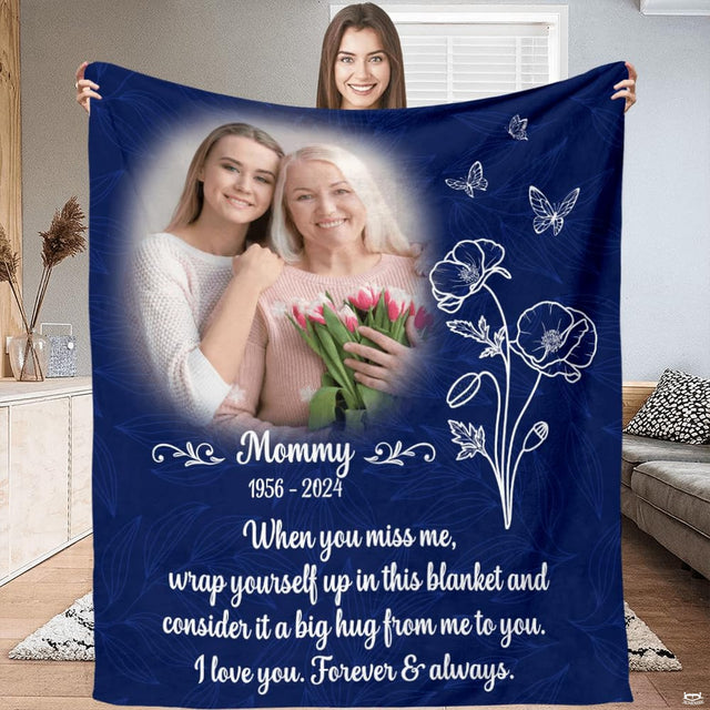 Navy botanical memorial throw blanket styled across a living room sofa
