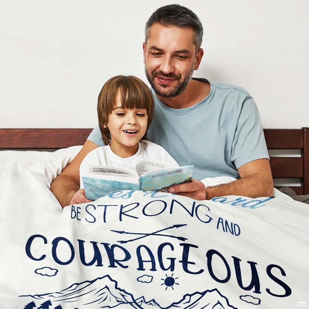 Sky blue and navy mountain bedding artwork featuring evergreen pine trees, clouds, and a rising sun.