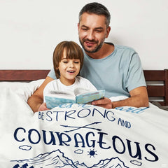 Sky blue and navy mountain bedding artwork featuring evergreen pine trees, clouds, and a rising sun.