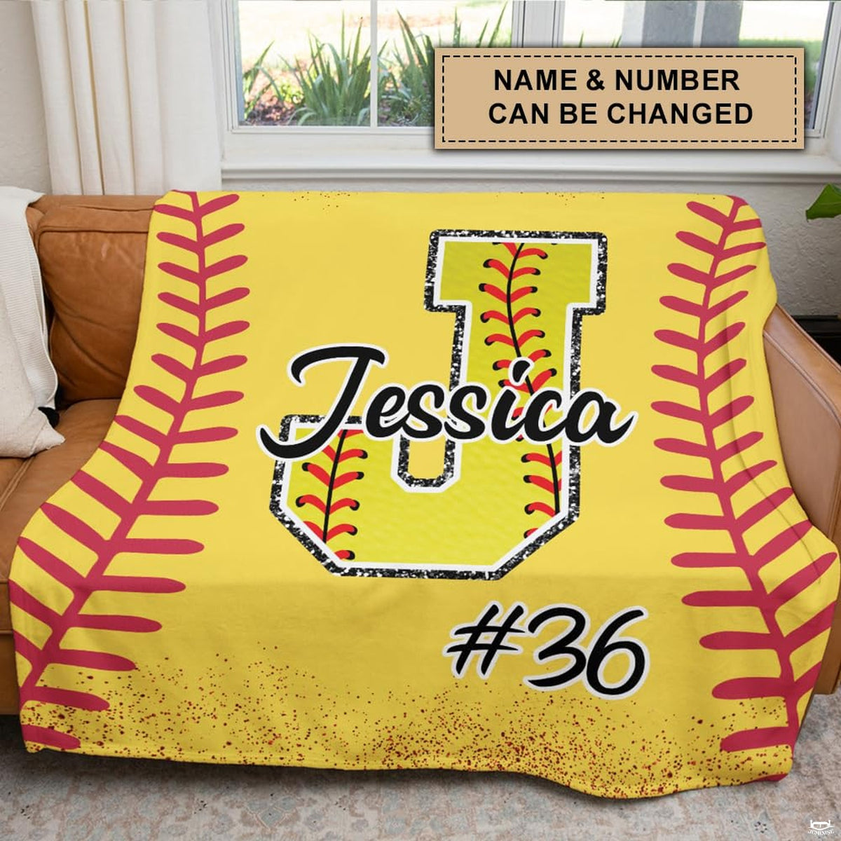 Close-up perspective of softball monogram initial and red chevron arcs on sports blanket