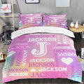 Monogram bedding displaying central initial letter surrounded by pastel pink and lavender word-cloud typography