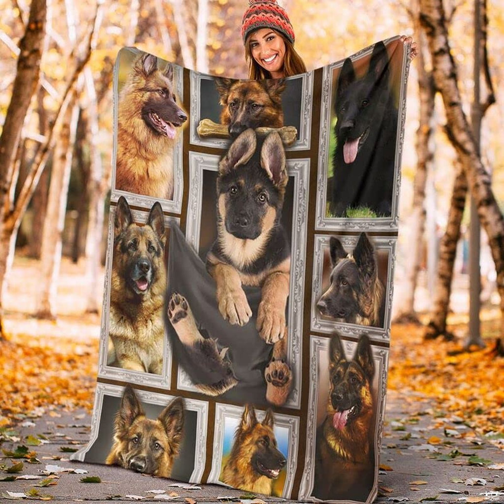 Model displaying the rectangular German Shepherd portrait blanket outdoors in an autumn park.