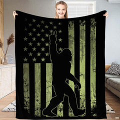 Tactical green Bigfoot American flag throw blanket featuring peace sign Sasquatch on olive drab flag